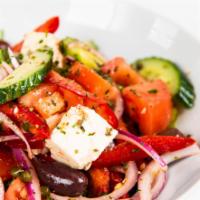Horiatiki Village Salad · Tomato, red onions, red peppers, cucumbers, capers, feta cheese and olive. Dressed with oliv...