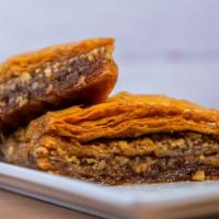 Baklava · Filo pastry with walnuts, butter, cinnamon soaked in our honey syrup.