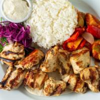 Shish Taouk · Young marinated chicken, vegetable ratatouille, rice pilaf, whipped garlic spread.