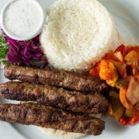 Kafta Kebab · Ground lamb, grilled vegetables, rice pilaf, yogurt sauce.