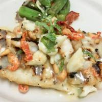 Rainbow Trout Trionfo · grilled topped with lump crabmeat, shrimp, crawfish tails, sundried tomatoes, pine nuts, min...