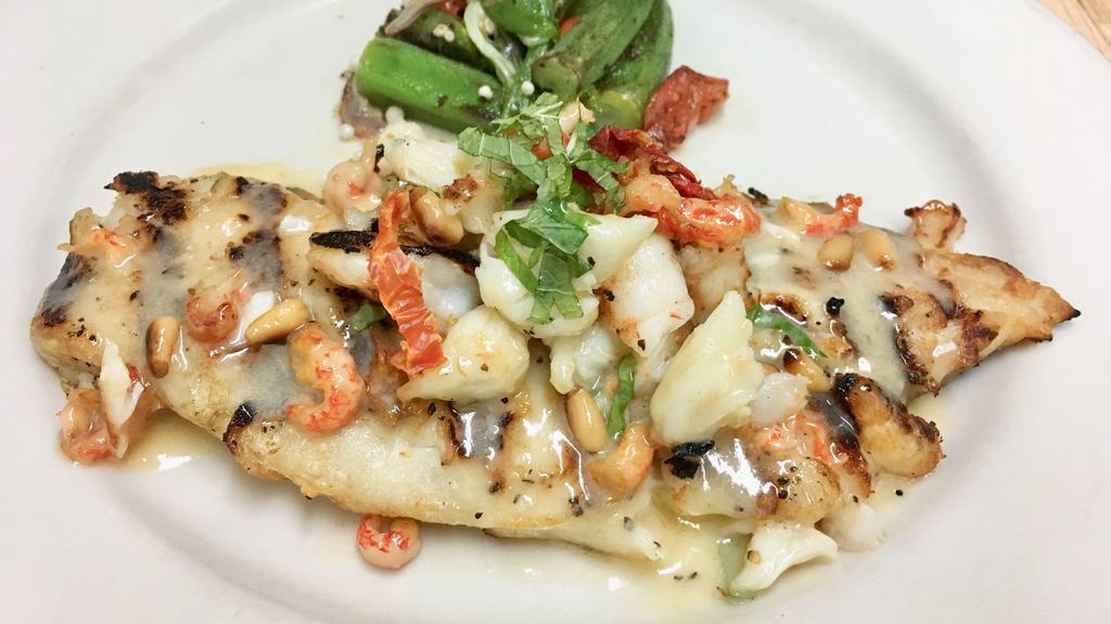 Rainbow Trout Trionfo · grilled topped with lump crabmeat, shrimp, crawfish tails, sundried tomatoes, pine nuts, mint, lemon butter served with vegetable of the day