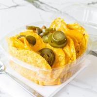 Nachos · Nacho chips smothered in warm cheese topped with jalapenos