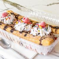 Churro Split · Your choice of 3 flavors of ice cream, two warm cinnamon sugar churros, topped with whipped ...