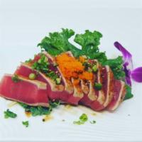 Tuna Tataki · Lightly seared tuna, cut into thin slices and served with ponzu vinaigrette and green onion.
