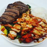 Sea Island Combination · 6 oz. lobster tail, Angus ribeye and grilled shrimp. Served with choice of side, steamed ric...