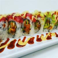 Rasta Roll · Spicy yellowtail, king crab, avocado 
and cucumber topped with salmon, 
tuna avocado and tem...