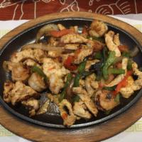 Chicken & Shrimp Fajitas · Tender-sliced chicken and shrimp grilled with red, yellow and green peppers, onions and toma...