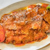 Iskender Kebab · Doner served over bread topped with fresh tomato sauce and yogurt.