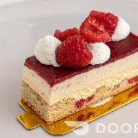 Raspberry Cheesecake · Raspberry brown butter cake, baked cheesecake, orange ricotta cream topped with raspberry ge...