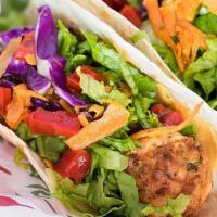 The Grilled Fish Taco · Seasoned grilled cod topped with our salad mix and wrapped in a flour tortilla. Served with ...