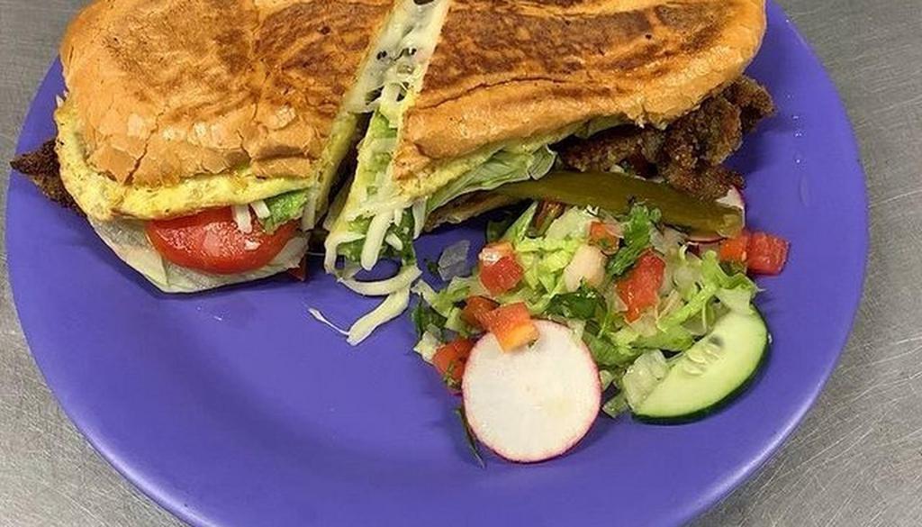 Torta/Milanesa · Breaded New York steak marinated with Mexican herbs, comes with fresh omelette, All the Tortas come with french bread, lettuce, avocado, tomatoes, grilled and raw onions, mayonnaise, mustard, cheese, chilies in vinegre.