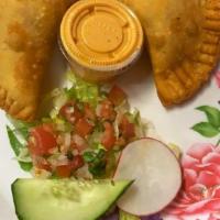 Empanadas/Pollo · Patty/ Stuffed with OxacaCheese, Shredded Chicken it's cooking with tomatoes onions, touch o...