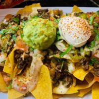 Carnitas/Nachos · Mega nachos, they come with Shredded pork Marinate with Mexican Herbs, re-fried pinto beans,...