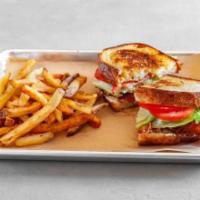 The Classic Blt Sandwich · Smoky bacon, thick slices of tomato, and crisp iceberg lettuce between two slices of toasted...