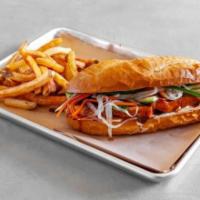 Tofu Banh Mi · Sesame and hoisin marinated tofu served hot on a Macrina bui roll with mayonnaise, sliced cu...