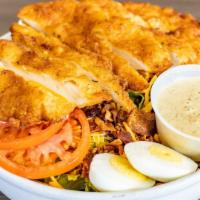 Chicken Cobb · Breaded chicken cutlet, shredded cheddar cheese, bacon, tomatoes, and hard boiled eggs serve...