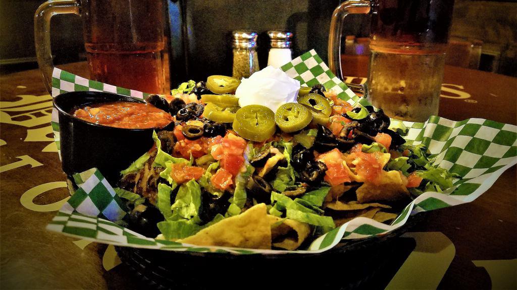 Traditional Pub Nachos · Tortilla chips, seasoned beef or chicken and melted jack-cheddar cheese topped with shredded lettuce, black olives, tomatoes and jalapenos. Served with sour cream and salsa.