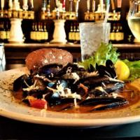 Mussels Malone · Succulent mussels sautéed with garlic, onions, tomatoes, thyme and white wine. Sprinkled wit...