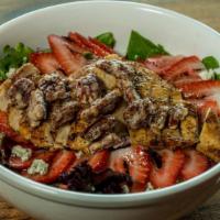 Strawberry Pecan Salad · Crisp romaine lettuce and spring greens topped with fresh strawberries, candied pecans, bleu...