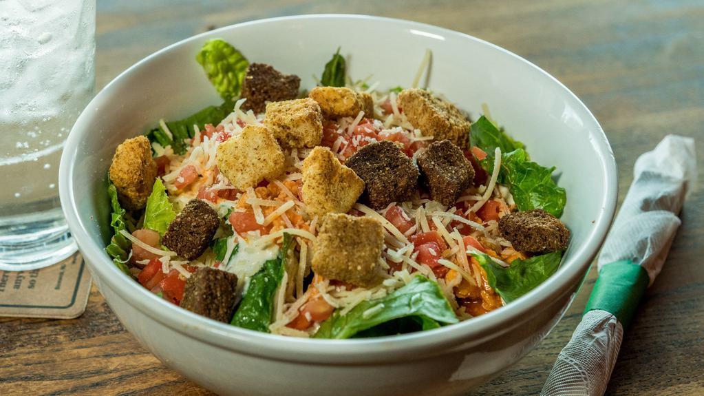 Angry Chicken Caesar Salad · Crisp romaine lettuce drizzled with Caesar dressing and topped with oven-baked chicken tossed in our signature angry sauce, diced tomatoes, shredded parmesan cheese and croutons.