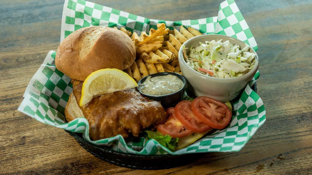 Fibber'S Fish Sandwich · Golden fried ale battered cod served on a bun with lettuce and tomato. Accompanied by waffle fries and coleslaw. Served with lemon, malt vinegar and lemon-dill tartar sauce.