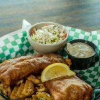 Fibber Flanagan'S Fish & Chips · Ale battered cod golden fried and accompanied by waffle fries and coleslaw. Served with lemo...
