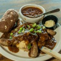 Bangers & Mash · Champ potatoes topped with four authentic Irish sausages, sautéed onions, rosemary onion gra...