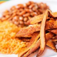 Milanesa De Pollo · Sliced either breaded Chicken Served with Mexican yellow rice and pinto beans accompanied wi...