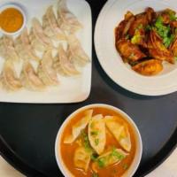 Crispy Chicken Dumplings · Nepalese dish. Steamed momos with sauce on side.
