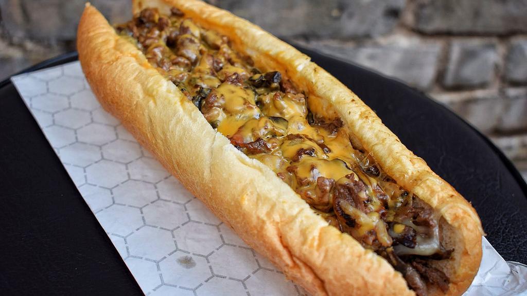 Cheesesteak Sandwich · Cheesesteak sandwich with thinly sliced USDA Texas Beef seasoned to perfection. Served on a buttery toasted Amoroso Roll. Choose your cheese. Add grilled toppings for extra flavor!