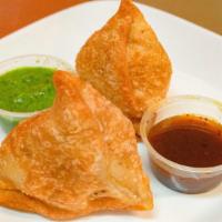 Vegetable Samosa · Crisp deep fried delicious mildly spiced stuffed potatoes and green peas.