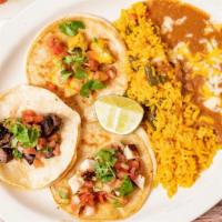 El Tio Taco Platter · Three soft corn tortilla tacos. Served with Mexican rice, refried beans, sour cream, pico de...