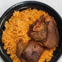 Jollof Rice And Goat-Meat · Jollof Rice and Goatmeat, Comes with coleslaw and peppered sauce.