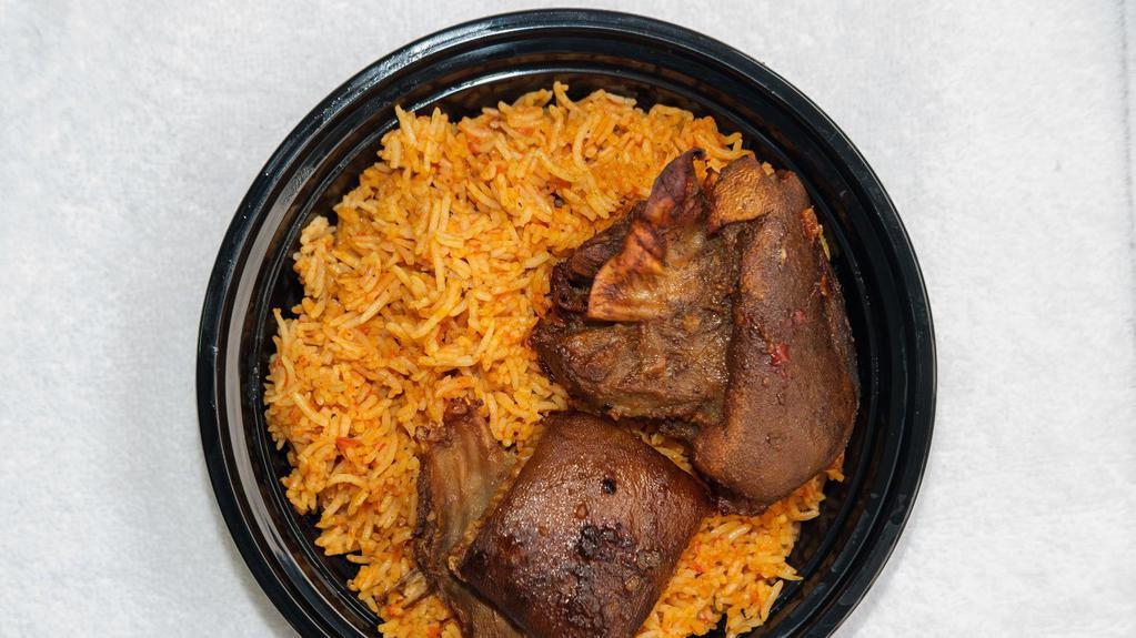 Jollof Rice And Goat-Meat · Jollof Rice and Goatmeat, Comes with coleslaw and peppered sauce.
