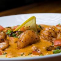 Shrimp & Grits · Jumbo shrimp, turkey sausage, tomatoes, and scallions served over cheese grits with cajun cr...