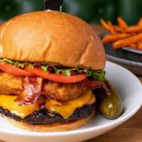 Carnegie Hall Burger · Topped with bacon, nosh sauce, cheddar cheese, jalapeño cream cheese bites, lettuce, and tom...
