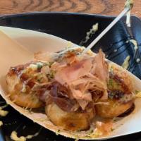 Takoyaki (4 Pcs) · Japanese dough ball topped with okonomiyaki sauce and bonito flakes.