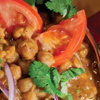 Channa Masala · Chickpeas cooked in an exotic curry, flavored with coriander leaves.