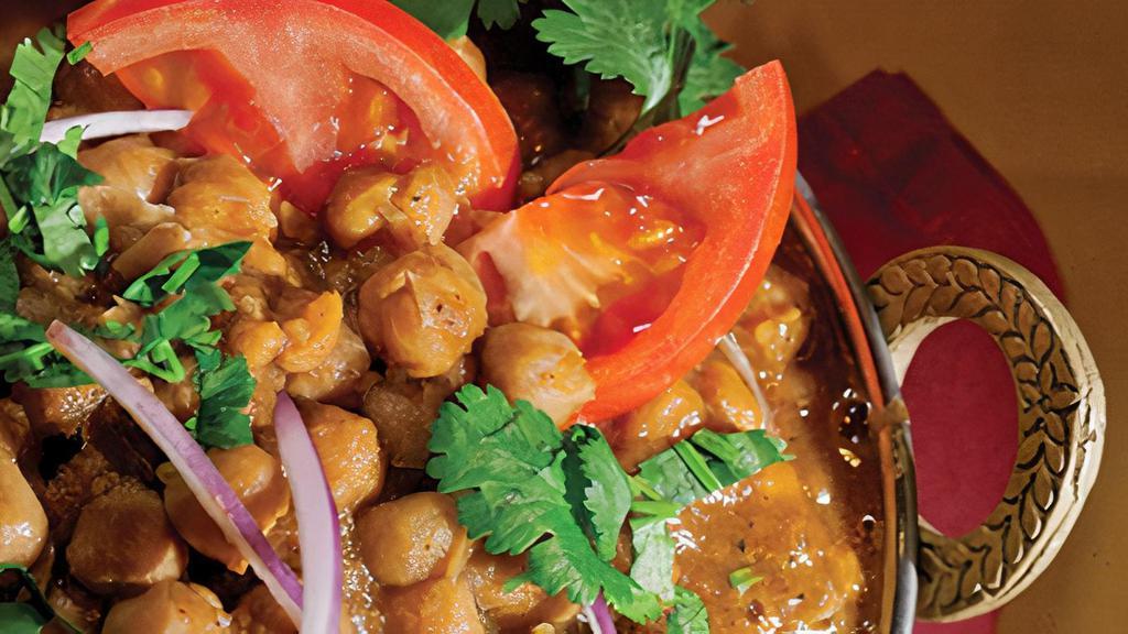 Channa Masala · Chickpeas cooked in an exotic curry, flavored with coriander leaves.