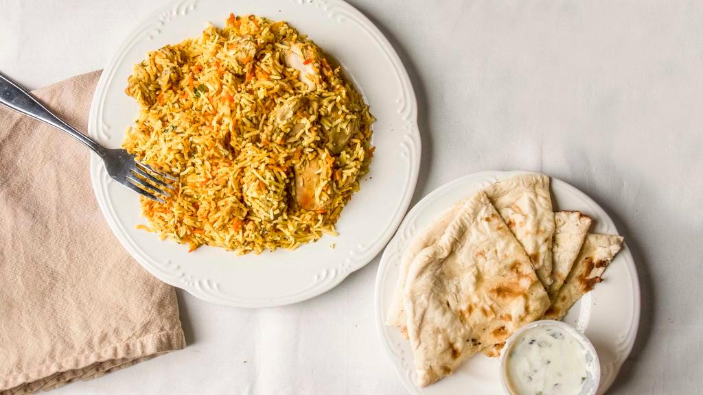 Chicken Biryani · Marinated chicken slow cooked in layers  with long grain basmati rice sealed  in large heavy bottom pots. A tradition carried on for generations.