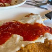 Veal Parmigiana With Spaghetti · Breaded veal cutlet baked with mozzarella cheese and topped with tomato sauce.