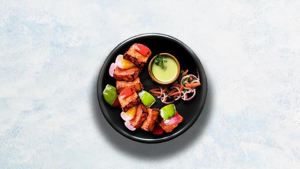 Paneer Tikka · Cubes of cottage cheese marinated in yogurt and glazed in a traditional Indian clay oven.
