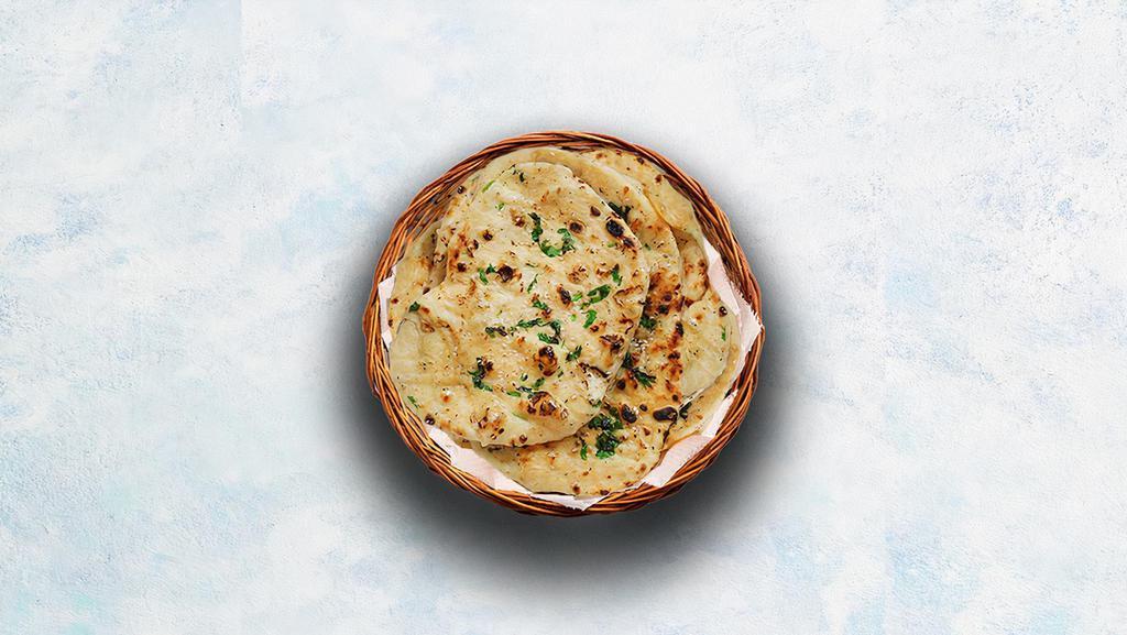 Garlic Naan · Indian flatbread baked to perfection in a traditional Indian clay oven and sprinkled with minced garlic and herbs.