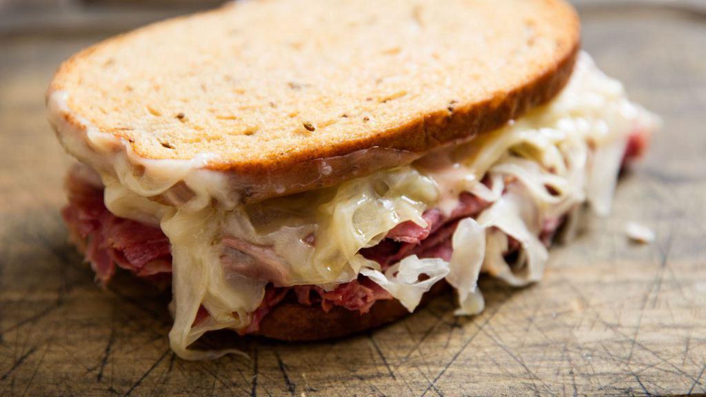 Classic Reuben Sandwich · First cut corned beef, swiss, sauerkraut, russian dressing on grilled rye bread. Includes Chips