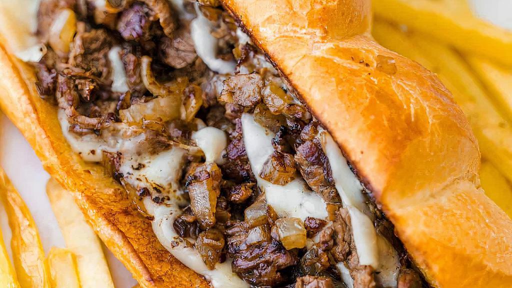 Steak & Cheese · Sliced rib-eye steak, provolone, grilled onions, lettuce, tomato and mayonnaise. Includes Chips