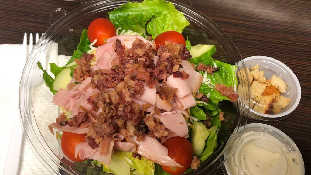 Blt Club With Blue Cheese Salad · Crisp Lettuce topped with Bacon, Ham, Turkey, Tomatoes, Cucumbers, Carrot Shreds, and Co-jack Cheese, with croutons and chunky Blue Cheese (Ranch can be substituted).