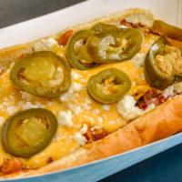 Nacho Ordinary Dog · House-made chili, nacho cheese sauce, queso fresco, pickled jalapeño and red onion.