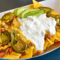 Supreme Nachos · Tortilla chips topped with house-made chili, nacho cheese sauce, Cheddar jack cheese, pickle...