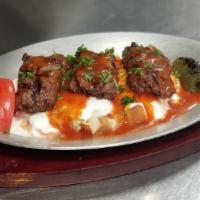 Adana Yogurt · Slightly hot. Ground beef and lamb served on sautéed homemade bread and topped with tomato a...